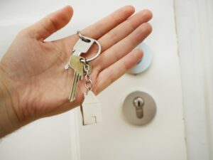 Tenants' hands holding the key to the rented apartment